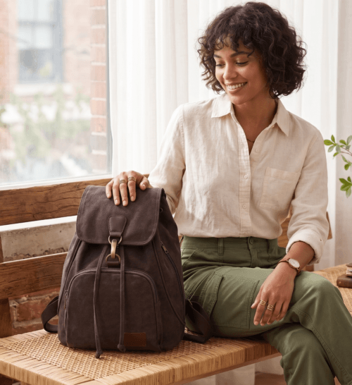 Daylife Leather dark brown canvas backpack showing front, side, padded back, and open upper interior compartment views.